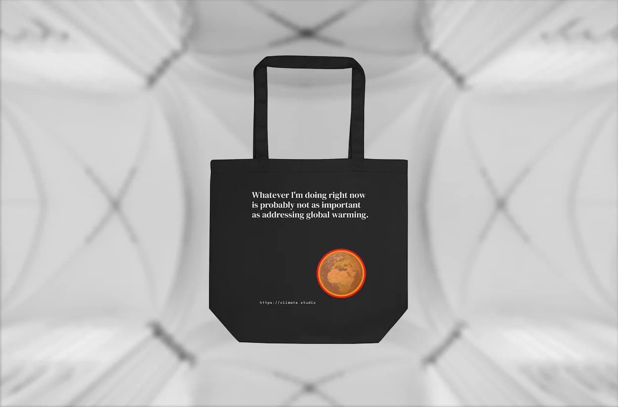 Black tote bag with climate message against architecture background