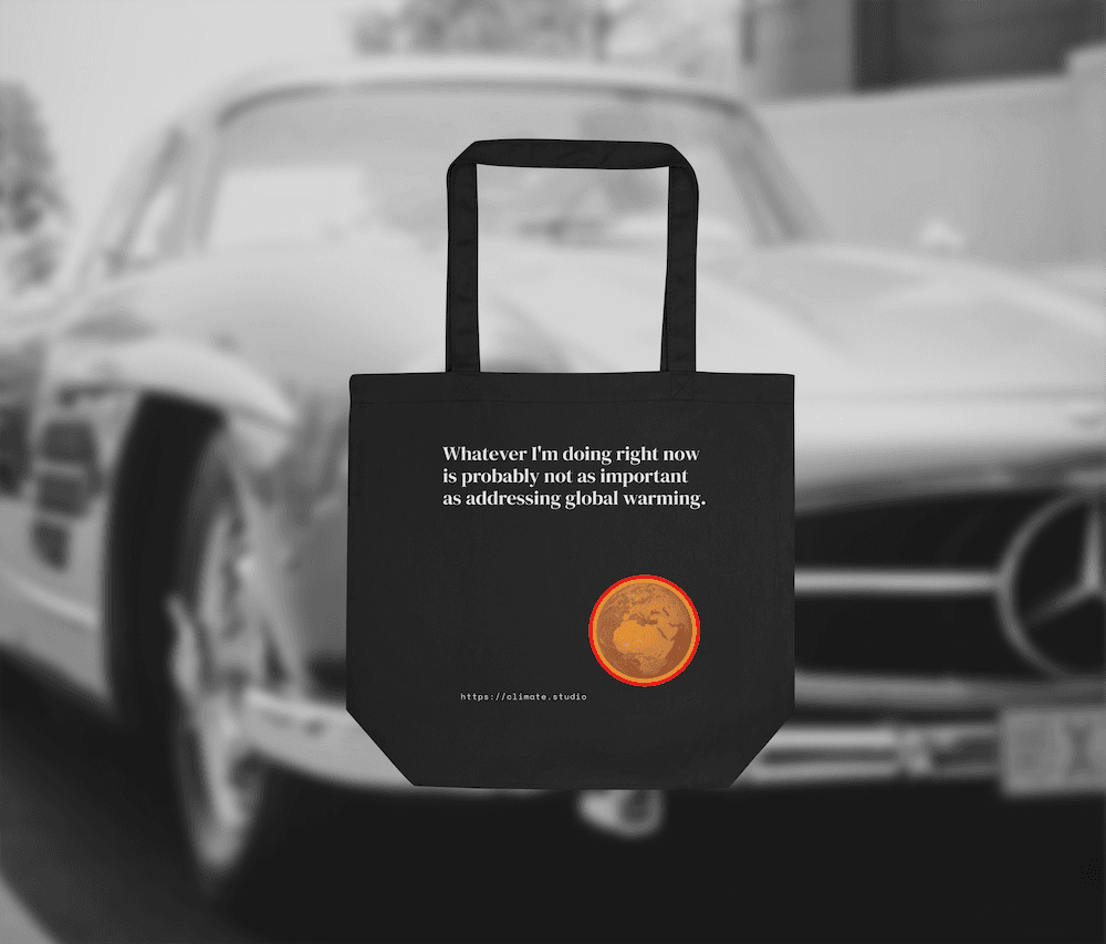 Black tote bag with climate message against classic car background
