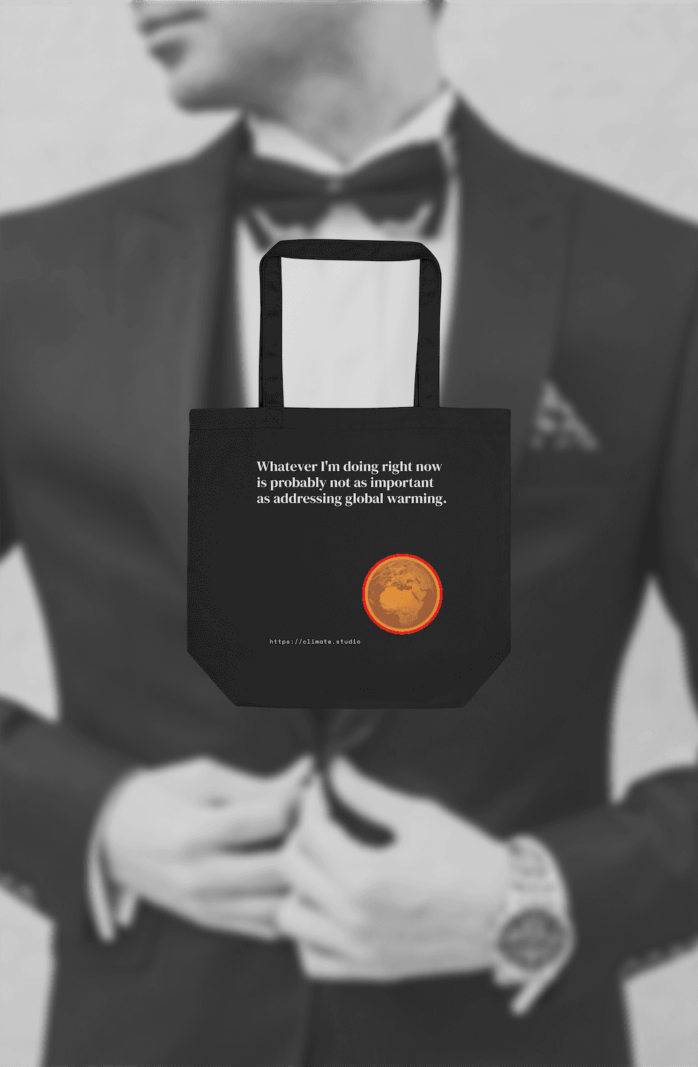 Black tote bag with climate message against deck background