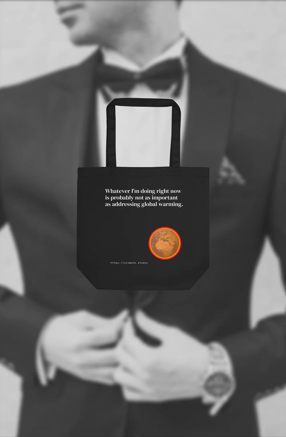 Black tote bag with climate message against deck background