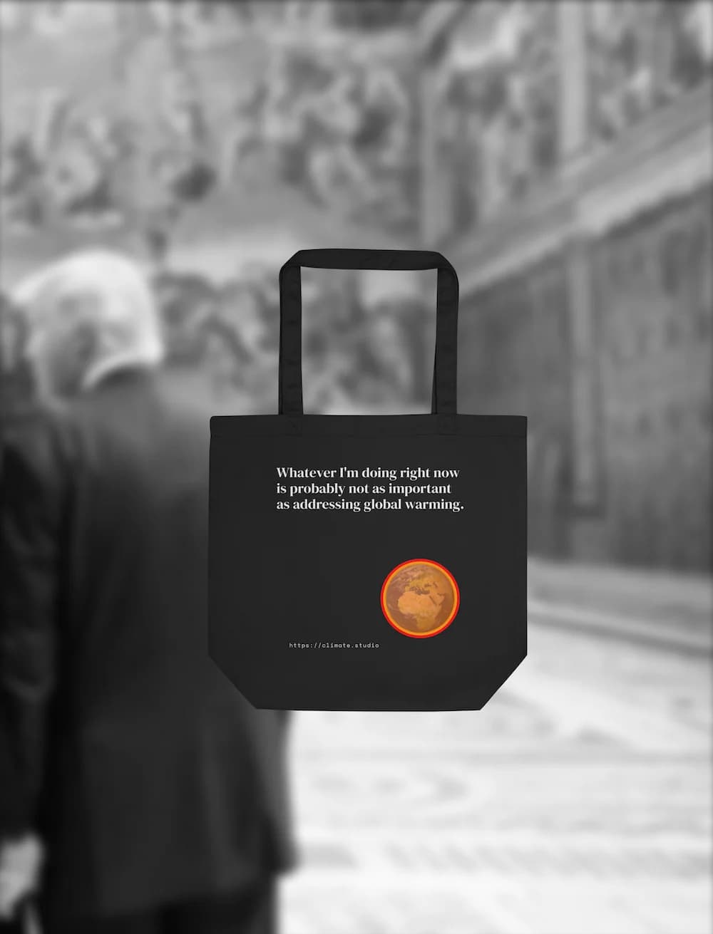 Black tote bag with climate message against Vatican background